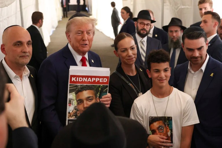 President Donald Trump poses for photos with family members of Edan Alexander, a hostage held by Hamas, after visiting the gravesite of Rabbi Menachem Mendel Schneerson, Monday, Oct. 7, 2024, in New York.