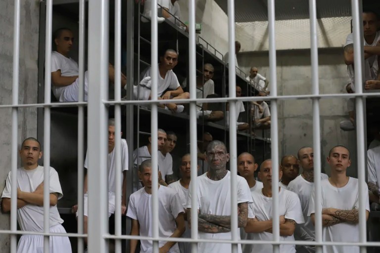 Inmates attend a class on social behavior from inside their shared cell during a press tour of the Terrorism Confinement Center, or CECOT, in Tecololuca, El Salvador, Oct. 12, 2023.
