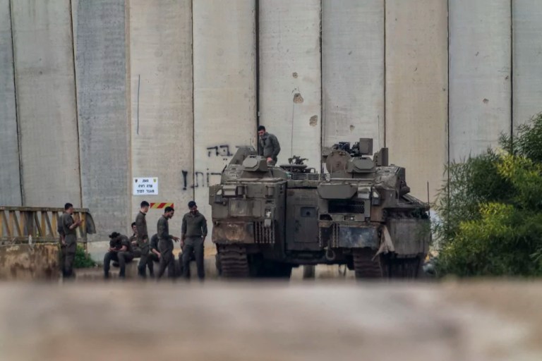 Israeli soldiers gather by the border with the Gaza Strip, in southern Israel
