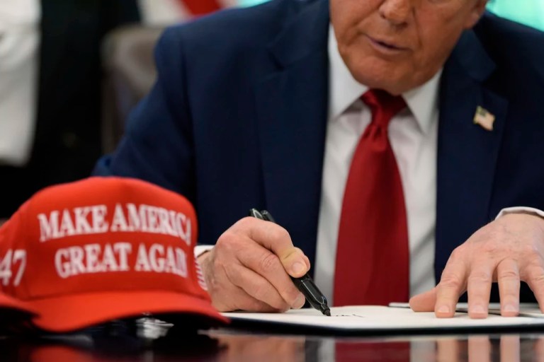 President Donald Trump signs an executive order relating to education in the Oval Office of the White House, Wednesday, April 23, 2025, in Washington.