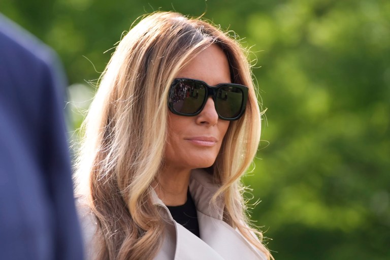 First lady Melania Trump listens as President Donald Trump speaks with reporters as she and the President depart on Marine One from the South Lawn of the White House, Friday, April 25, 2025, in Washington. The President and first lady will be traveling to Rome and the Vatican to attend the funeral for Pope Francis.