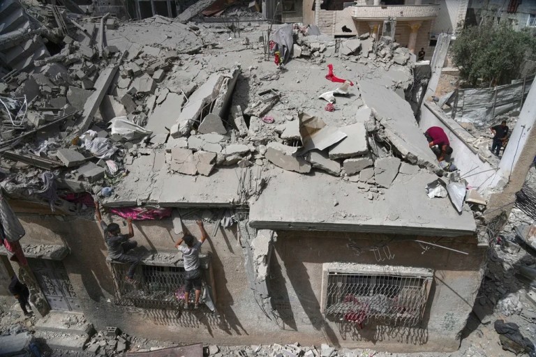 Palestinians inspect the house of the Jabr family after it was hit earlier by an Israeli army strike killing at least 10 people, in Jabalia, northern Gaza Strip, Sunday, May 18, 2025. (AP Photo/Jehad Alshrafi)