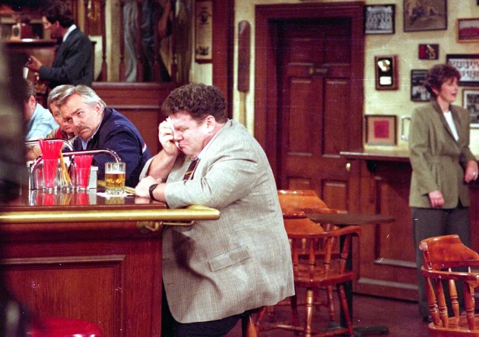George Wendt, right, who portrayed Norm Peterson, sheds a tear on the set of the popular NBC series, "Cheers," as John Ratzenberger, portraying Cliff Calvin, looks away during a scene while taping the final episode in Los Angeles, California, April 1, 1993.