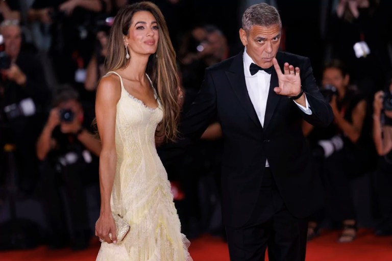 Amal Clooney and George Clooney pose for photographers upon arrival for the premiere of the film 'Wolfs' during the 81st edition of the Venice Film Festival in Venice, Italy, on Sunday, Sept. 1, 2024.