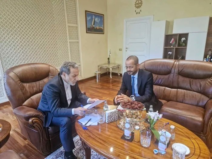 In this photo released by the Iranian Foreign Ministry, Iranian Foreign Minister Abbas Araghchi, left, reads a paper in a meeting with his Omani counterpart Sayyid Badr Albusaidi at the Omani Embassy in Rome during the fifth round of Iran-U.S. negotiations, Friday, May 23, 2025.