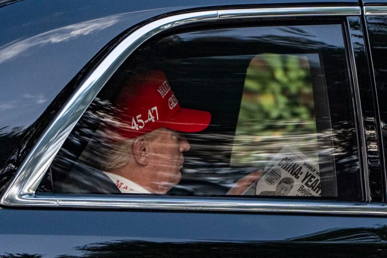 President Donald Trump reads The NY Post as he arrives at the Trump National Golf Club in Jupiter, Florida, April 5, 2025.