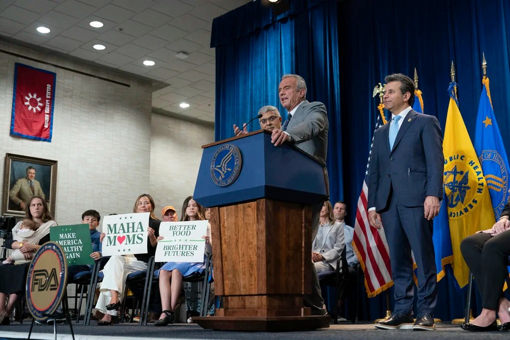 Health and Human Services Secretary Robert F. Kennedy Jr. flanked by Director of the National Institutes of Health Jay Bhattacharya, left, and Food and Drug Administration (FDA) commissioner Marty Makary, right, speaks during a news conference on the FDA's intent to phase out the use of petroleum-based synthetic dyes in the nation's food supply at the Hubert Humphrey Building Auditorium in Washington, Tuesday, April 22, 2025. (AP Photo/Jose Luis Magana)