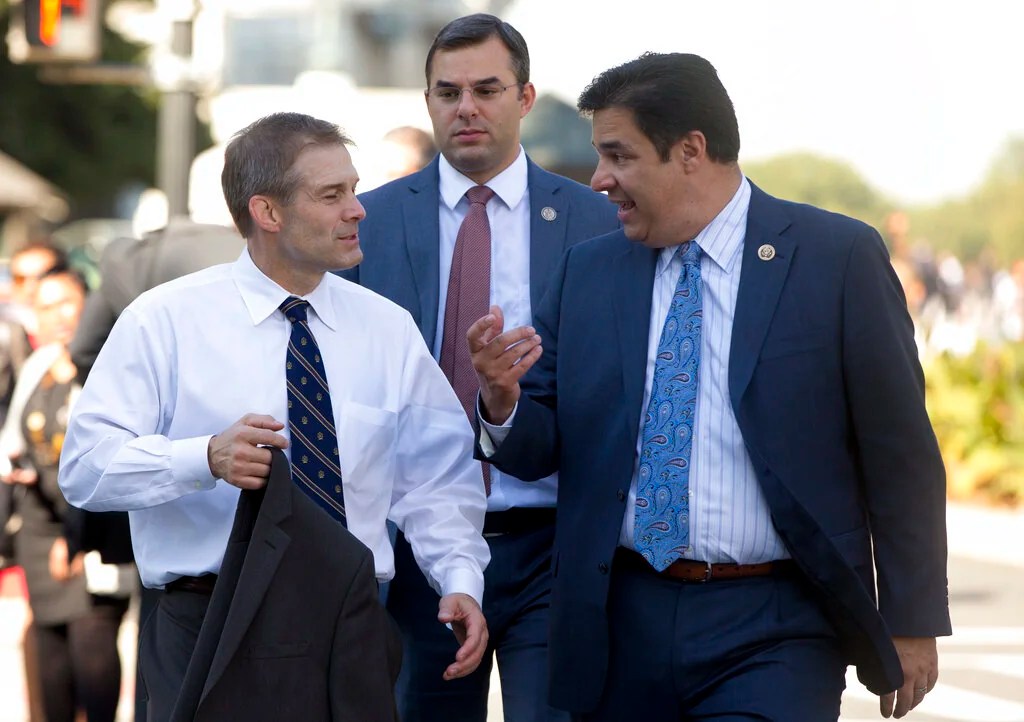 Chair of the Freedom Caucus Rep. Jim Jordan, R-Ohio, left, walks with fellow Freedom Caucus members,  Rep. Justin Amash, R-Mich., center, and Rep. Raul Labrador, R-Idaho, fright, from the Capitol to the Longworth House Office Building on Capitol Hill in Washington, Wednesday, Oct. 21, 2015. Rep. Paul Ryan, R-Wis., seeking unity in a place it's rarely found, is telling House Republicans he will serve as their speaker only if they embrace him by week's end as their consensus candidate.  (AP Photo/Carolyn Kaster)