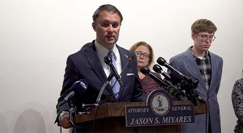 Attorney General Jason Miyares standing at a podium