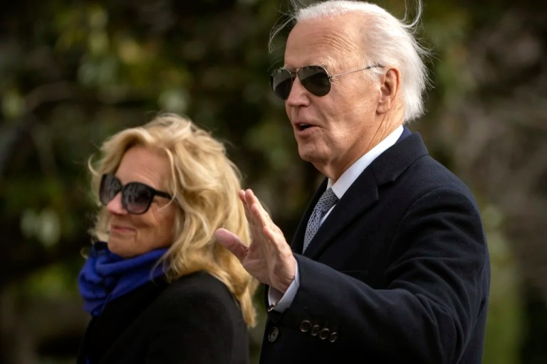 President Joe Biden gestures as he and first lady Jill Biden walk across the South Lawn of the White House, Thursday, Jan. 2, 2025, in Washington after returning from Camp David.