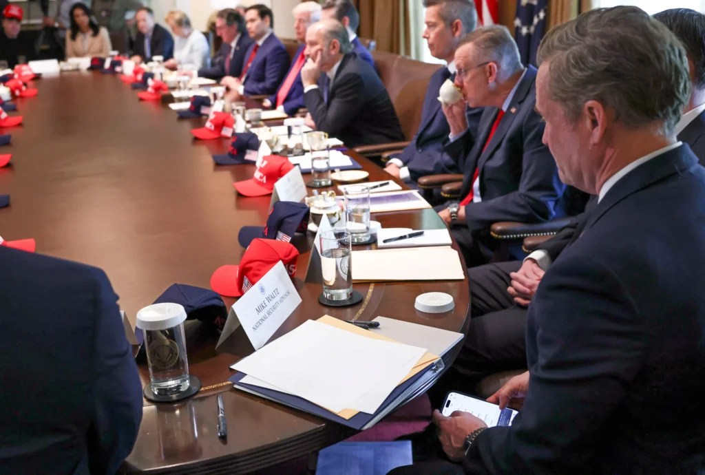 U.S. National Security Advisor Mike Waltz checks his mobile phone while attending a cabinet meeting held by U.S. President Donald Trump at the White House in Washington, D.C., U.S., April 30, 2025.
