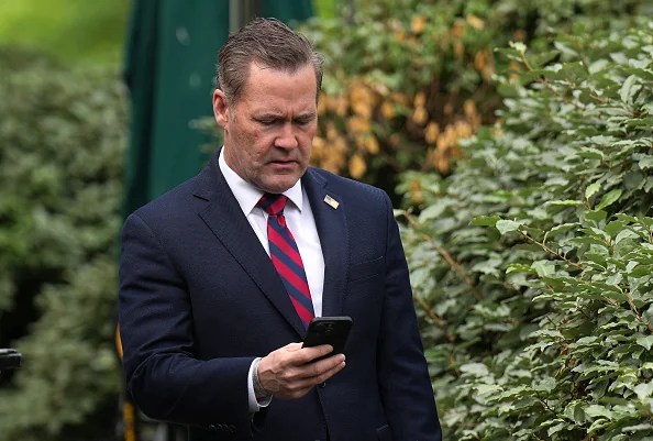 National Security Advisor Michael Waltz looks at his phone as he prepares for a TV interview at the White House on May 01, 2025 in Washington, DC. This week marks the first 100 days of U.S. President Donald Trump's second term.