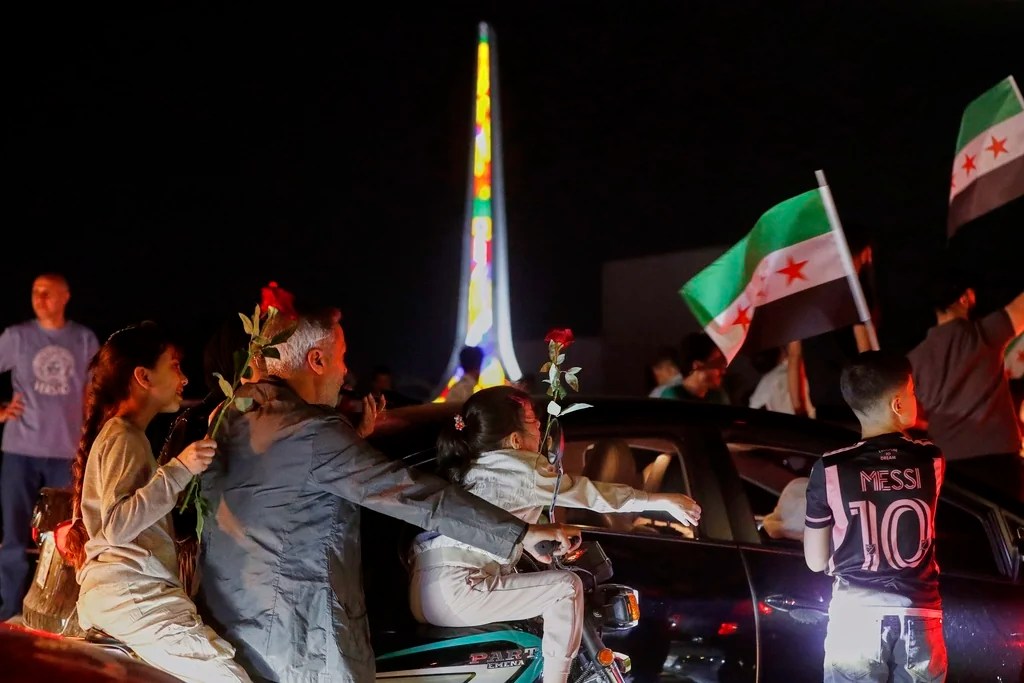 Syrians celebrate in Umayyad Square after U.S. President Donald Trump announced plans to ease sanctions on Syria and move toward normalizing relations with its new government to give the country 'a chance at peace,' in Damascus, Syria, Tuesday, May 13, 2025. 