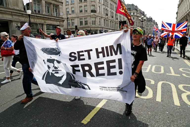 Supporters of far-right activist Stephen Yaxley-Lennon known as Tommy Robinson protest in Oxford Street, London, Saturday, Aug. 3, 2019. Demonstrators carrying England’s flag gathered in central London to demand the release of Robinson. Singing “We want Tommy out,