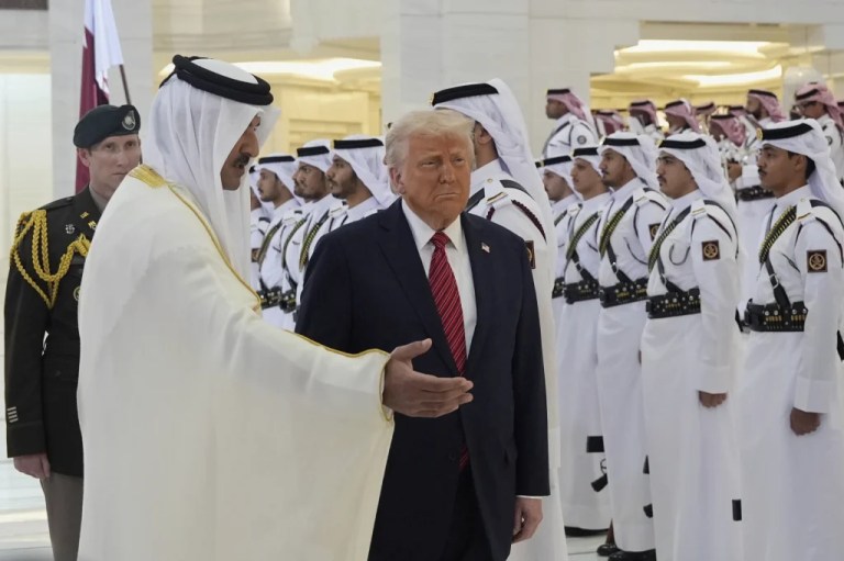 Qatar's Emir Sheikh Tamim bin Hamad Al Thani welcomes President Donald Trump during an official welcoming ceremony at the Amiri Diwan in Doha, Qatar, Wednesday, May 14, 2025.