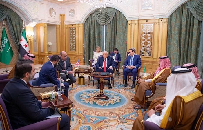 This combination of photos shows President Donald Trump, left, in Riyadh, Saudi Arabia, on May 13, 2025 and Syrian President Ahmad al-Sharaa in Ankara, Turkey, on Feb. 4, 2025.