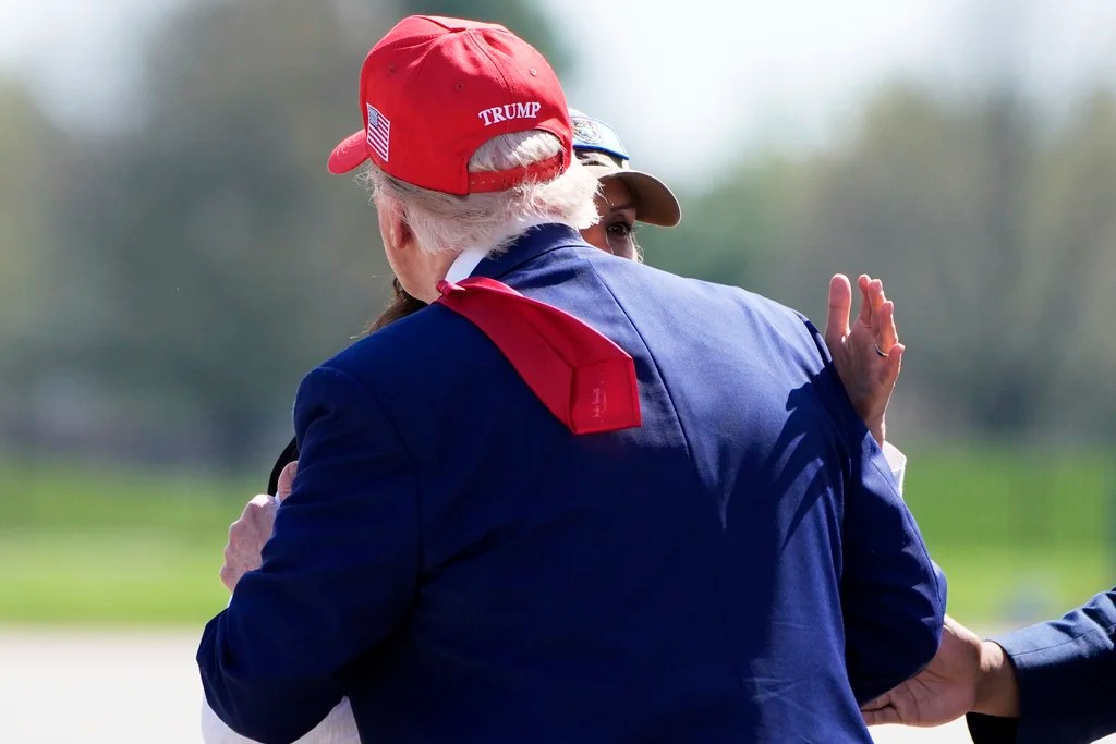 President Donald Trump greets Michigan Gov. Gretchen Whitmer as he arrives on Air Force One at Selfridge Air National Guard Base, Tuesday, April 29, 2025, in Harrison Township, Mich. (AP Photo/Alex Brandon)