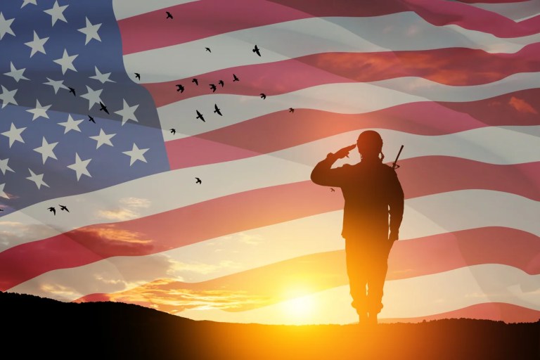 Sunset with flag and soldier
