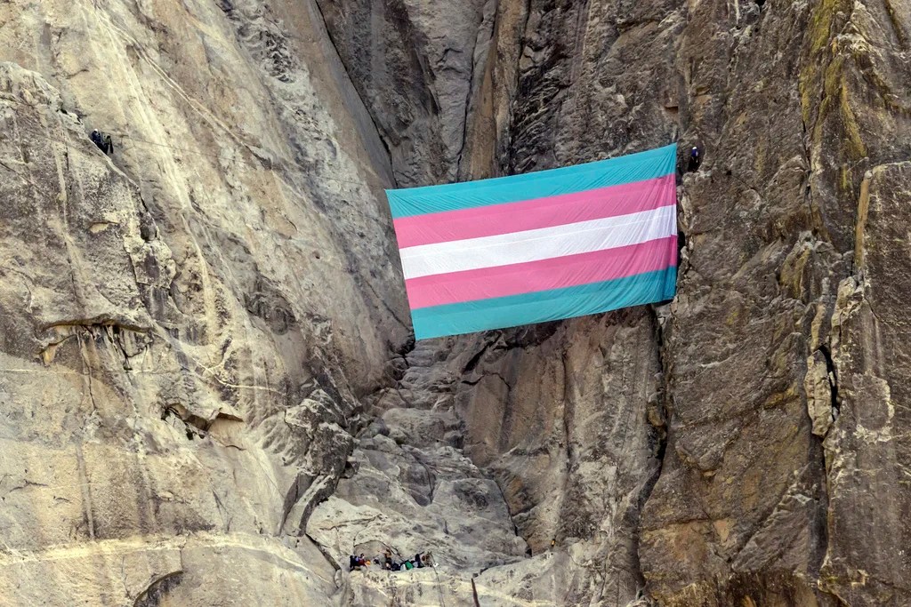 A group of climbers unfurl a trans pride flag on El Capitan in Yosemite National Park, Calif., on Tuesday, May 20, 2025.