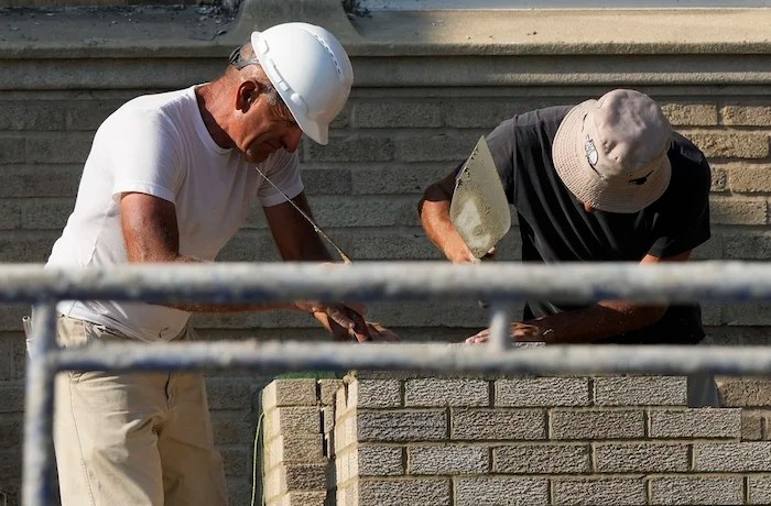 Construction workers work at a residential building site in Chicago