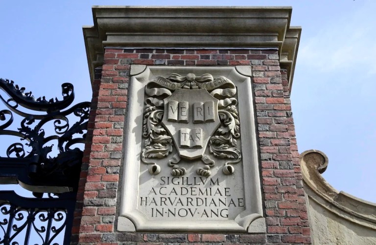 In this Sunday, March 13, 2016 photo, a relief sculpture rests on a gate to the entrance of Harvard University, in Cambridge, Massachusetts.
