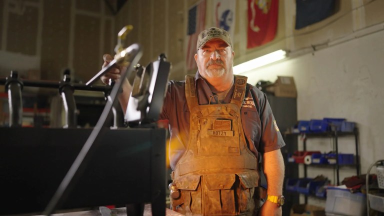 Retired sergeant Steve Hotz, who served in the 325th Regiment, 82nd Airborne Division of the U.S. Army, speaks with other volunteers who served in law enforcement and other military branches.