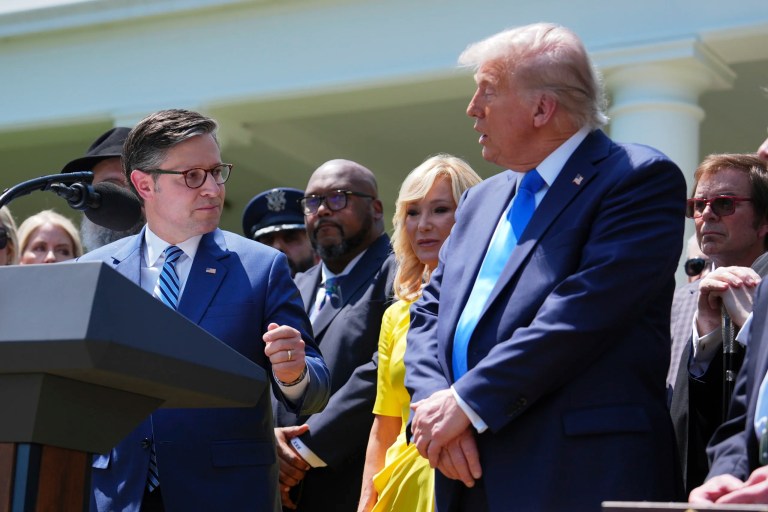 House Speaker Mike Johnson, R-La., left, and President Donald Trump, right, speak during a National Day of Prayer event in the Rose Garden of the White House, Thursday, May 1, 2025, in Washington. (AP Photo/Evan Vucci)