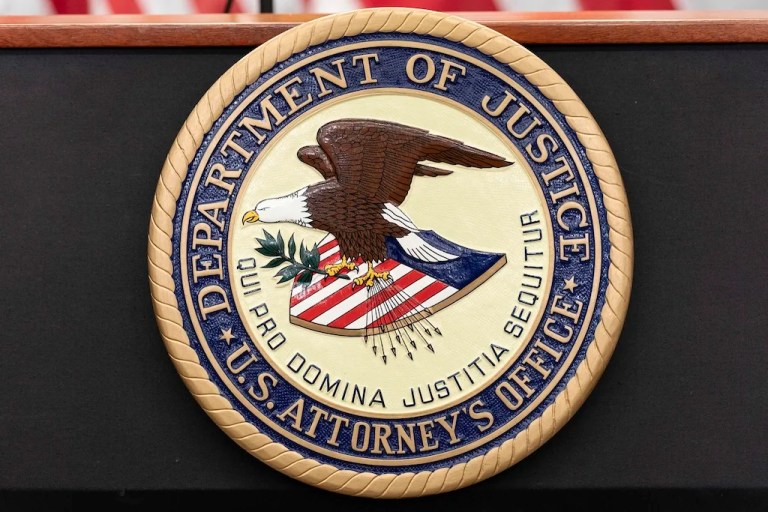 The seal of Department of Justice U.S. Attorney's Office is seen during a news conference in Washington, Thursday, May 22, 2025. (AP Photo/Jose Luis Magana)