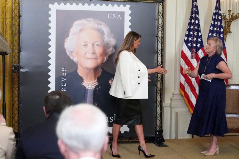 First lady Melania Trump, left, reaches to shake the hand of Dorothy Bush Koch as they unveil a U.S. Postal Service Stamp honoring former first lady Barbara Bush, Thursday, May 8, 2025, in the East Room of the White House in Washington.