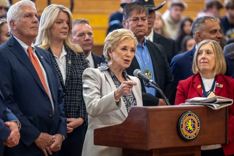 U.S. Secretary of Education Linda McMahon, center, joined by local elected officials speaks during a visit to Massapequa High School, Friday, May 30, 2025, in Massapequa, N.Y. (Alejandra Villa Loarca/Newsday via AP)