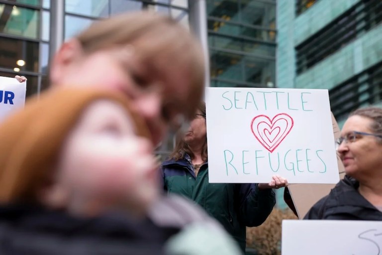 FILE - People gather outside the U.S. District Court after a federal judge blocked President Donald Trump's effort to halt the nation's refugee admissions system Feb. 25, 2025, in Seattle. (AP Photo/Ryan Sun, File)