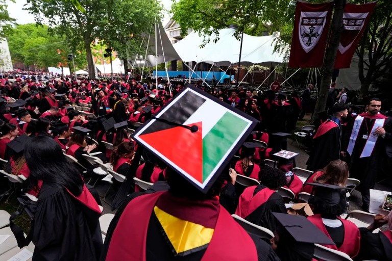 A student displays the Palestinian flag on his mortar board as graduates take their seats in Harvard Yard during commencement at Harvard University, Thursday, May 23, 2024, in Cambridge, Massachusetts.
