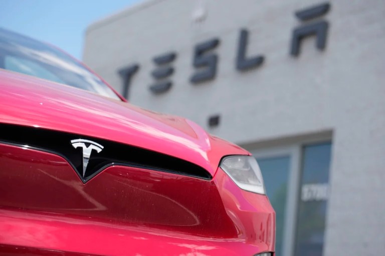 FILE - A Model X sports-utility vehicle sits outside a Tesla store in Littleton, Colo., June 18, 2023. (AP Photo/David Zalubowski, File)
