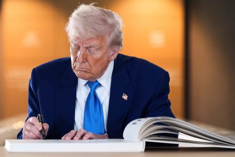 President Donald Trump signs the guest book after touring the Abrahamic Family House, Friday, May 16, 2025, in Abu Dhabi, United Arab Emirates. (AP Photo/Alex Brandon)