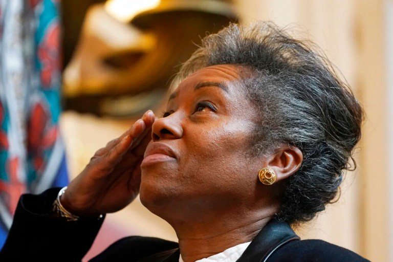 Virginia Lt. Gov. Winsome Earle-Sears salutes the flag during the opening of the senate session at the Capitol Tuesday March 1, 2022, in Richmond, Va. Earle-Sears is a former Marine. (AP Photo/Steve Helber)