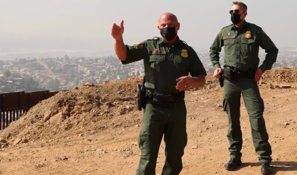 Border Patrol San Diego Chief Patrol Agent Aaron Heitke (left) and Border Patrol Chief Rodney Scott (right) discuss changes to the border wall system during the past three decades during a tour of San Diego, CA, in October 2020. (Anna Giaritelli / Washington Examiner)