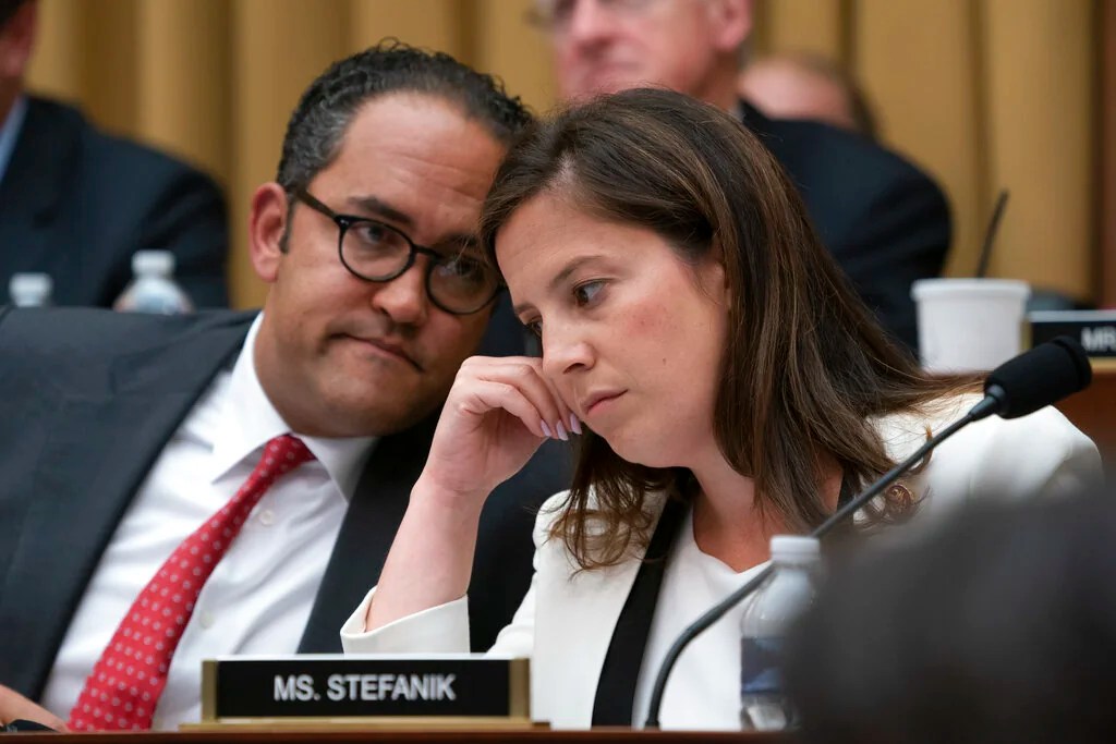 Rep. Will Hurd, R-Texas, left, and Rep. Elise Stefanik, R-N.Y., right, talk as former special counsel Robert Mueller testifies to the House Intelligence Committee.