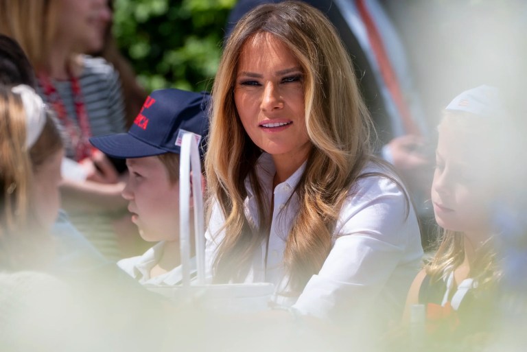 First lady Melania Trump participates in flag decorating during a Take Our Child to Work Day event in the Jacqueline Kennedy Garden at the White House, Tuesday, May 20, 2025, in Washington.