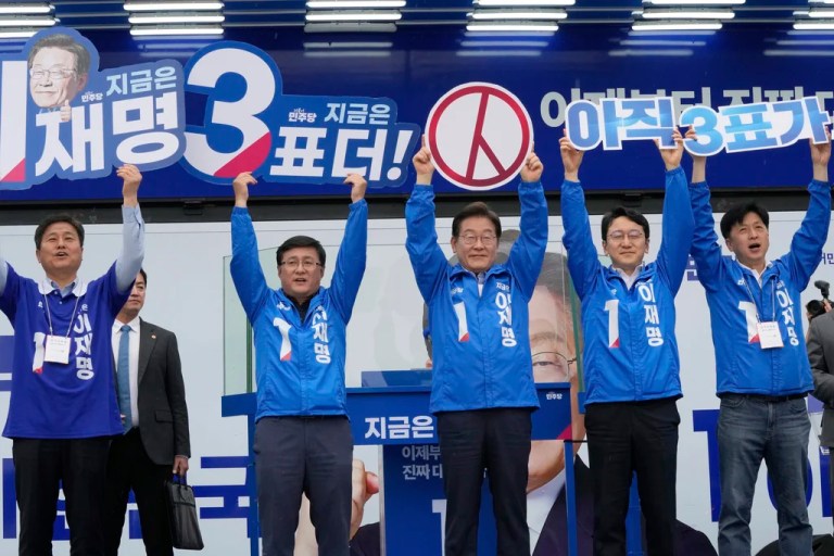 South Korea's Democratic Party's presidential candidate Lee Jae-myung, center, poses with his party members during a presidential election campaign in Seoul, South Korea, Monday, June 2, 2025.