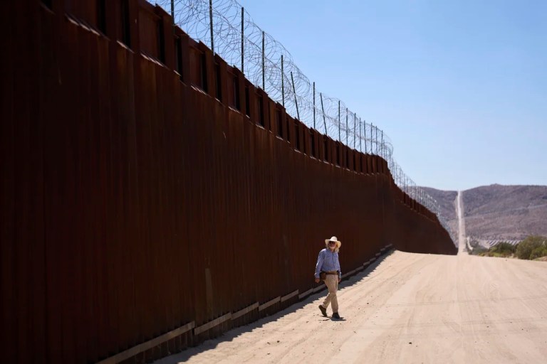 Volunteer Sam Schultz walks along a stretch of empty high desert where, in years past, he would sometimes see hundreds of migrants daily crossing the border separating Mexico and the United States, Thursday, June 5, 2025