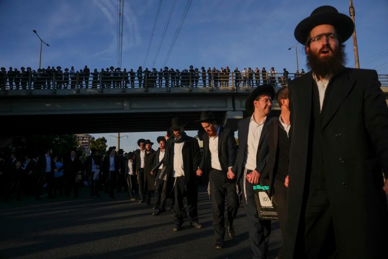 Ultra-Orthodox Jewish men block a highway during a protest against army recruitment in Bnei Brak, Israel, on March 2, 2025.