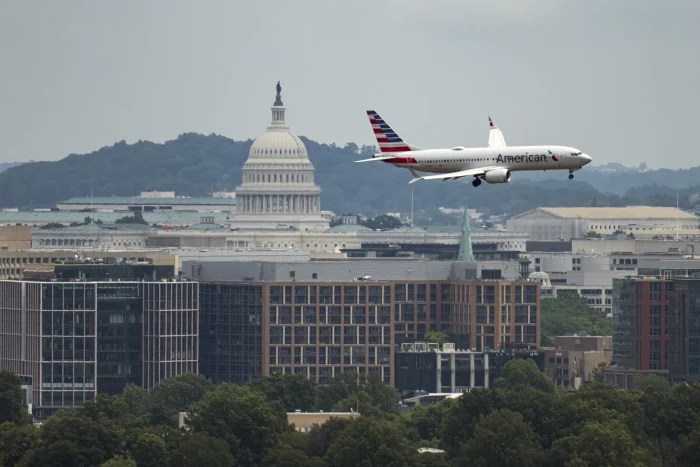 UNITED STATES - JUNE 14: An American Airlines jet comes in for a landing at Ronald Reagan Washington National Airport on Saturday, June 14, 2025, before the start of President Donald Trump's military parade in Washington. The FAA has ordered a pause of all arrivals and departures to and from the airport during the parade. (Bill Clark/CQ Roll Call via AP Images)
