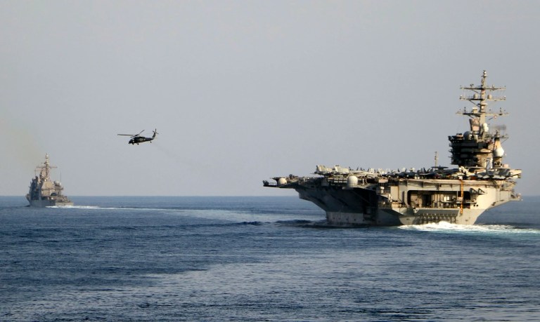 The aircraft carrier USS Dwight D. Eisenhower and other warships cross the Strait of Hormuz into the Persian Gulf on Sunday, Nov. 26, 2023.