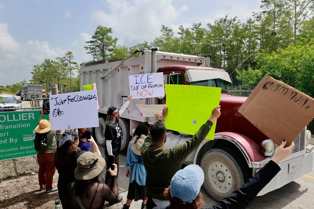Environmental advocates and protesters at the Dade-Collier Training and Transition Airport on Tamiami Trail E, Ochopee, Fla., on Saturday, June 28, 2025, object to the "Alligator Alcatraz" being built at the facility. (Mike Stocker /South Florida Sun-Sentinel via AP)
