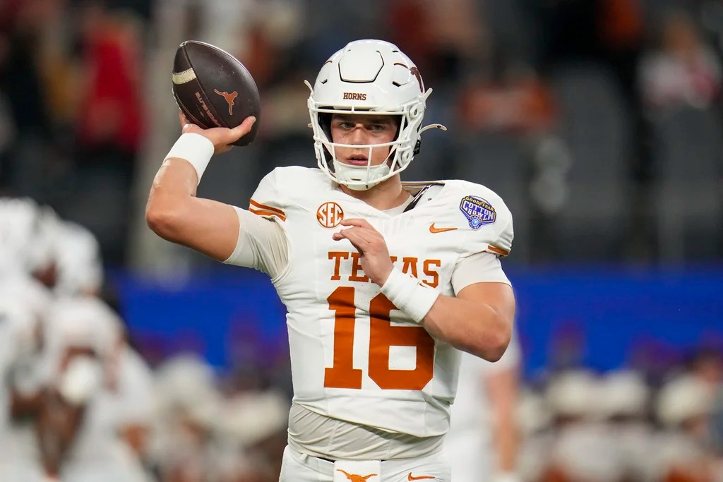 Texas quarterback Arch Manning (16) works out during the Cotton Bowl College Football Playoff semifinal game against between Texas and Ohio State, Friday, Jan. 10, 2025, in Arlington, Texas.