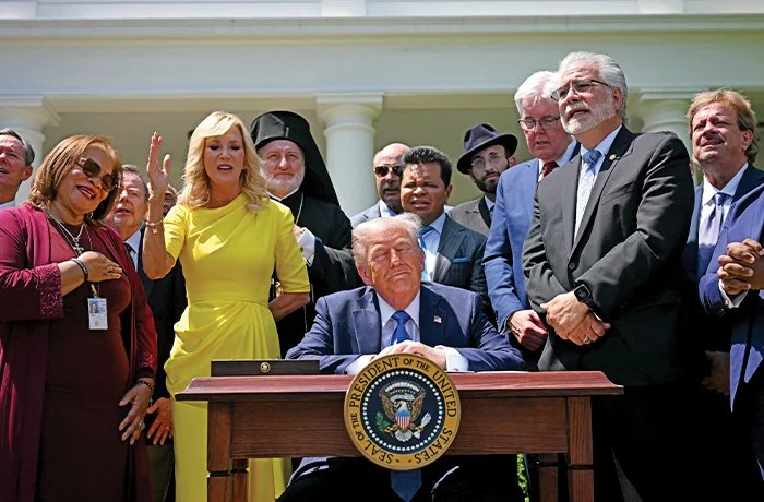 In the White House Rose Garden, pastors and other visitors sing during a National Day of Prayer event before Trump signs an executive order establishing the Religious Liberty Commission.