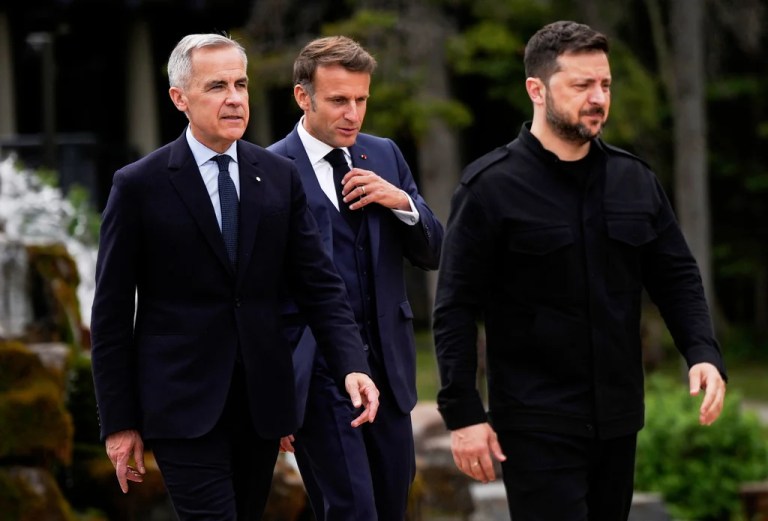 Canada's Prime Minister Mark Carney, front left, Ukrainian President Volodymyr Zelenskyy, front right, and French President Emmanuel Macron, back centre, arrive for the family photo of world leaders and invited guests at the G7 Summit in Kananaskis, Alberta, Tuesday, June 17, 2025. (Darryl Dyck/The Canadian Press via AP)