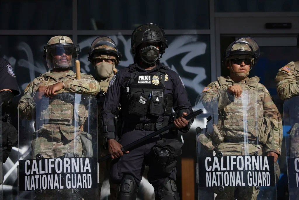 US Customs and Border Protection officers and National Guard soldiers are posted at the entrances of the Federal Building in Los Angeles while protesters rally during a demonstration in response to a series of US Immigration and Customs Enforcement (ICE) raids throughout the country, on Tuesday, June 10th, 2025.