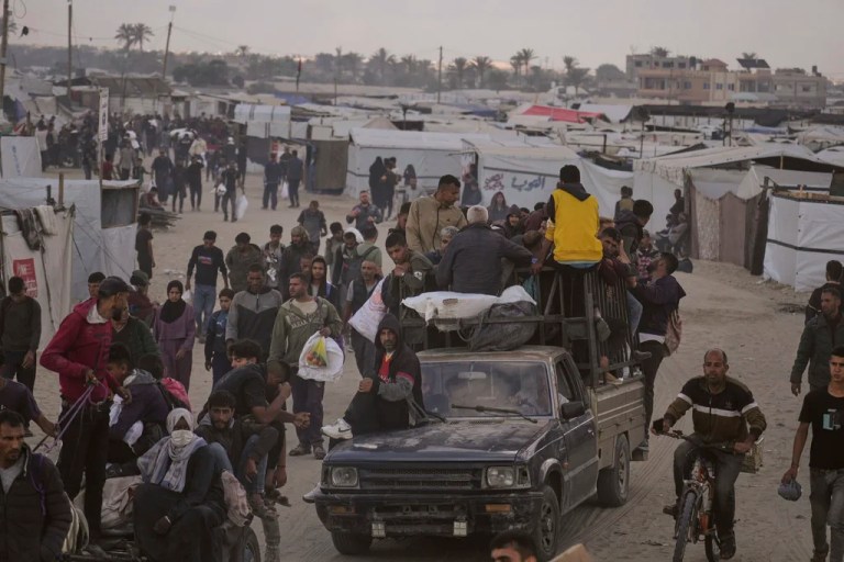 Palestinians carry bags filled with food and humanitarian aid provided by the Gaza Humanitarian Foundation, a U.S.-backed organization approved by Israel, in Khan Younis, southern Gaza Strip, on Tuesday, June 3, 2025.