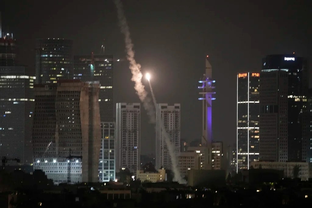 Israeli air defense system fires to intercept missiles over Tel Aviv, Israel, early Sunday, June 15, 2025.